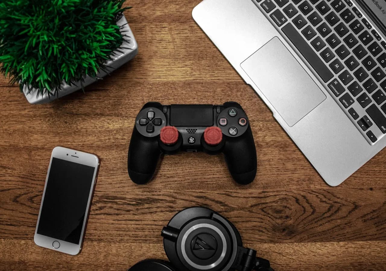 A desk with game controller and some other hardware on it