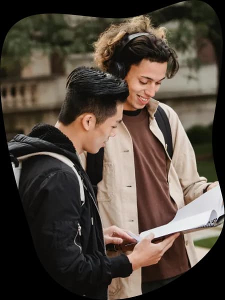 Multiethnic students reading document in folder