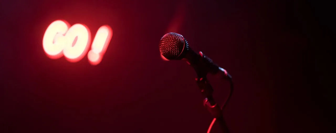 A mic with a GO! neon sign