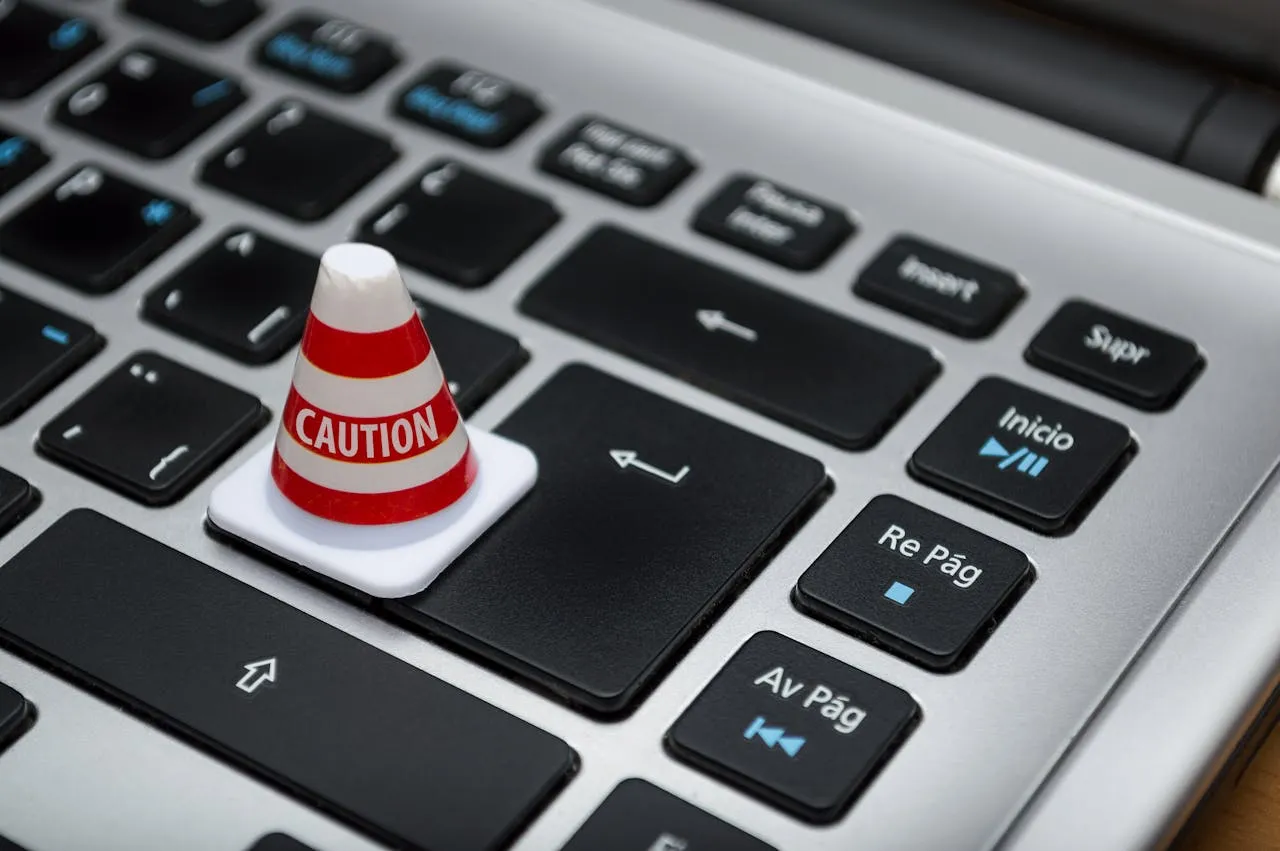 A laptop keyboard with a caution warning