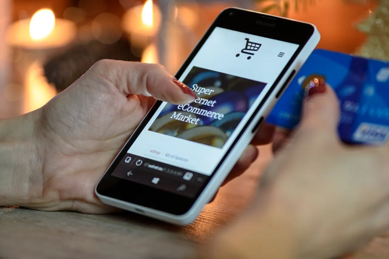 A mobile phone in hand with a web app open