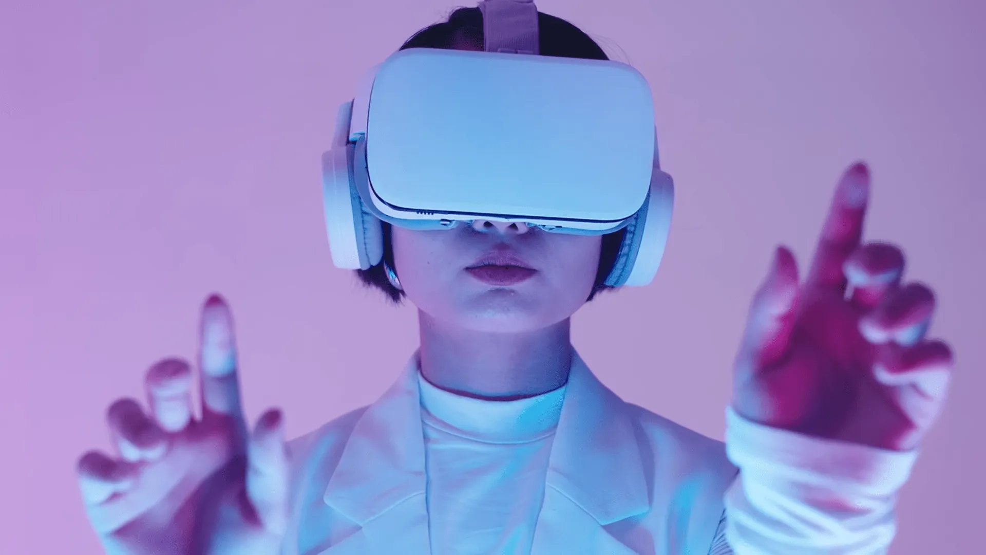 A girl wearing vr headset plays in virtual space doing hand motions in air